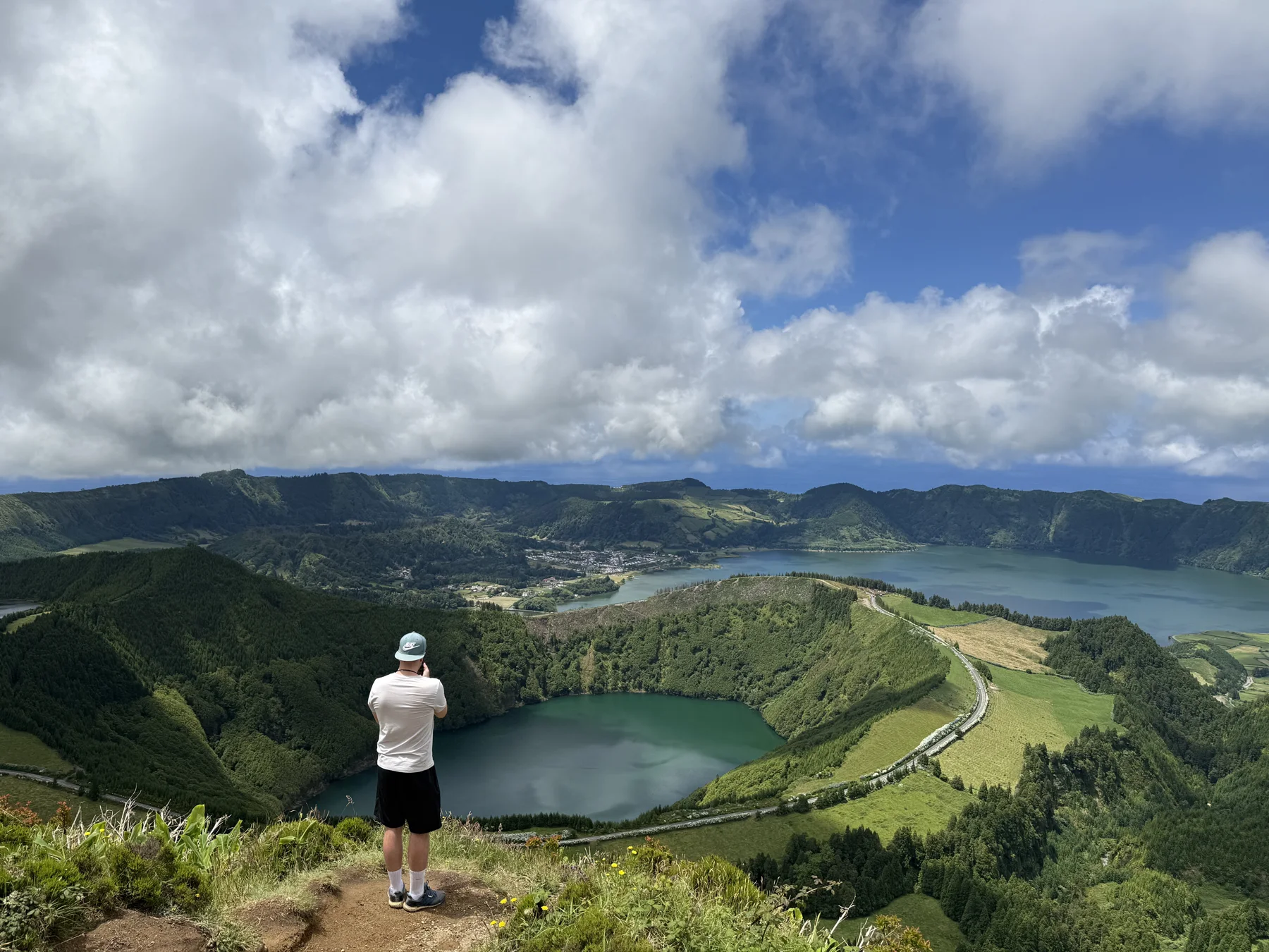 View from Miradouro da Boca do Inferno across the emerald-green Lagoa de Santiago towards the Lagoa Azul of Sete Cidades